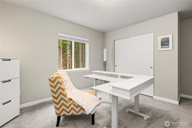 home office featuring light carpet and baseboards