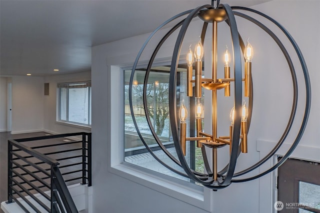 room details with baseboards, recessed lighting, and a notable chandelier