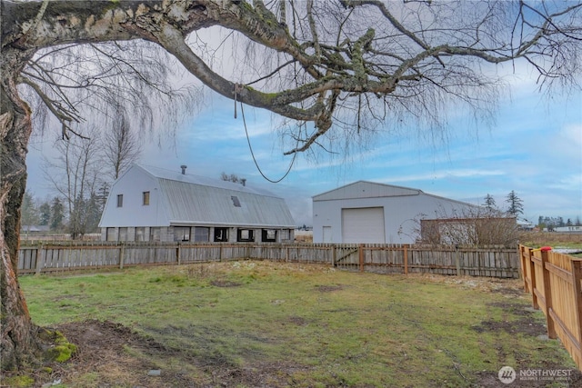 view of yard featuring a garage and a fenced backyard