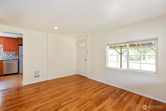 1314 N Callow Ave, Bremerton, WA 98312 - unfurnished living room featuring recessed lighting, visible vents, light wood-style flooring, and baseboards