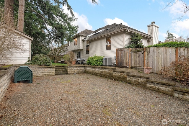 view of property exterior featuring cooling unit and fence