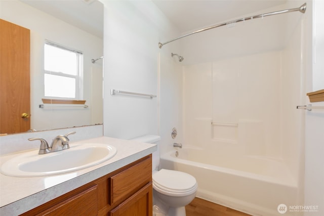 bathroom featuring bathing tub / shower combination, vanity, and toilet