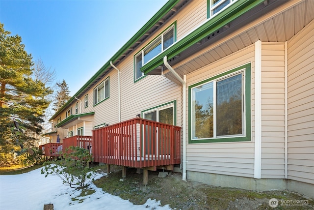 snow covered property featuring a deck