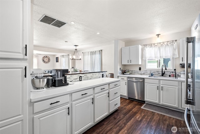 kitchen with stainless steel appliances and white cabinetry