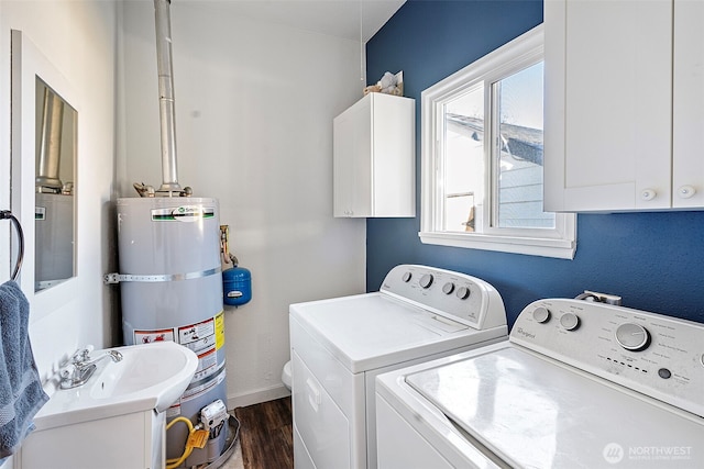 laundry room with dark wood-style flooring, water heater, cabinet space, washer and dryer, and baseboards