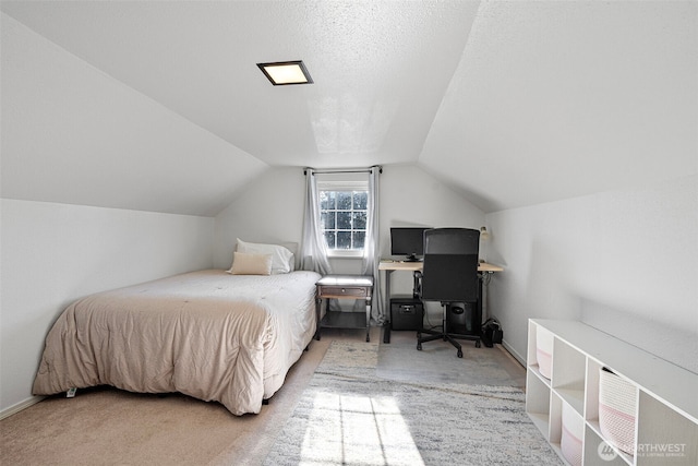 carpeted bedroom featuring lofted ceiling, a textured ceiling, and baseboards