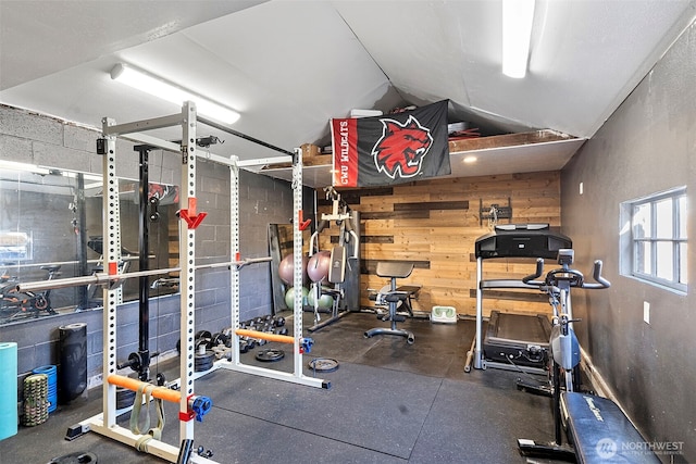 exercise room with wood walls