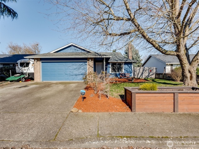 single story home featuring a garage, brick siding, driveway, and fence