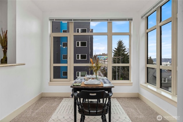 dining room featuring carpet and baseboards