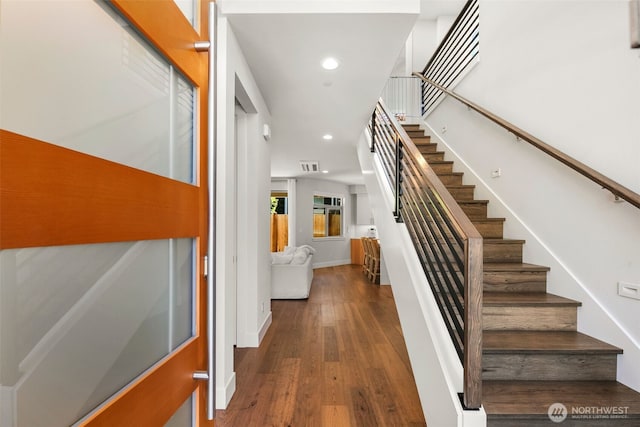 stairs with recessed lighting, visible vents, baseboards, and wood finished floors