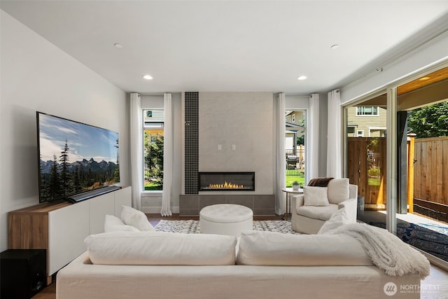 living area featuring plenty of natural light, a fireplace, and recessed lighting