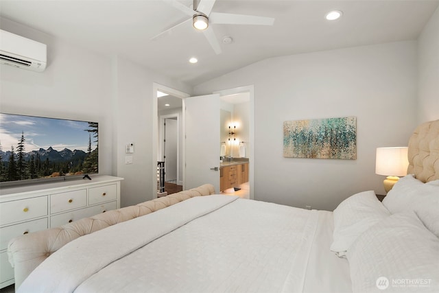 bedroom featuring vaulted ceiling, a wall unit AC, connected bathroom, and recessed lighting