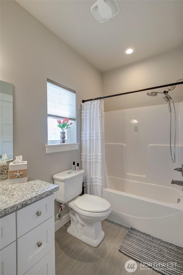 bathroom featuring shower / bath combination with curtain, vanity, and toilet