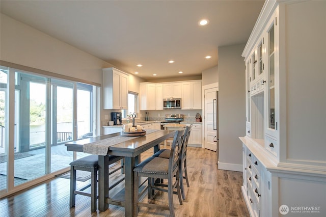 dining room featuring light wood-style floors and recessed lighting