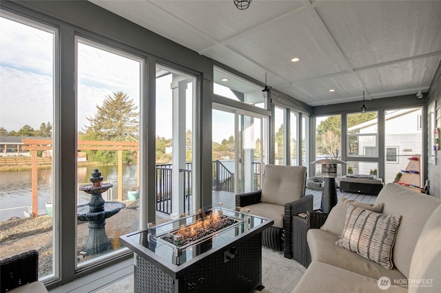 sunroom / solarium featuring a water view and a wealth of natural light