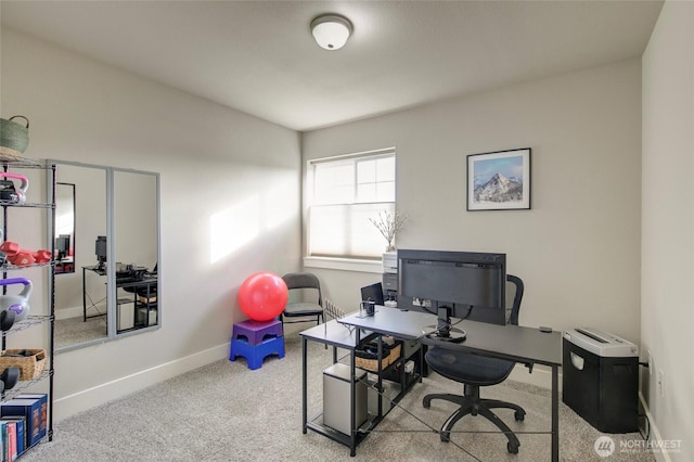 carpeted home office with baseboards