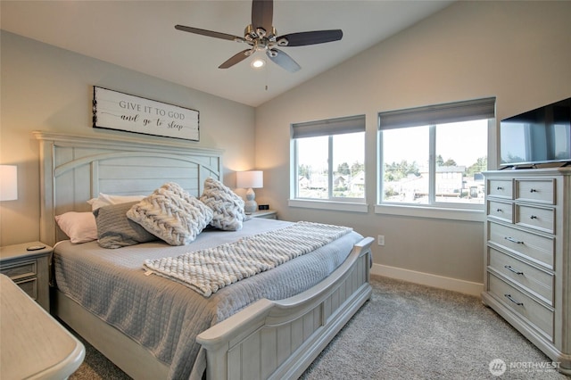 bedroom with a ceiling fan, lofted ceiling, light carpet, and baseboards