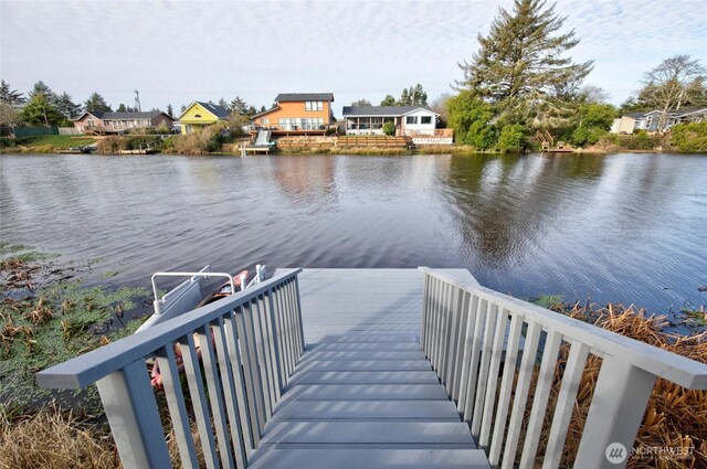 dock area with a water view and a residential view