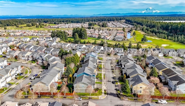 birds eye view of property featuring a residential view, a mountain view, and a wooded view