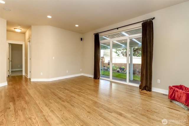 unfurnished room with light wood-type flooring, baseboards, and recessed lighting