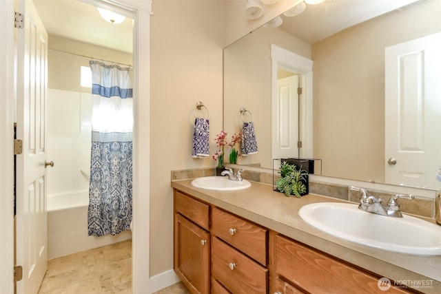 bathroom with shower / tub combo with curtain, a sink, and double vanity