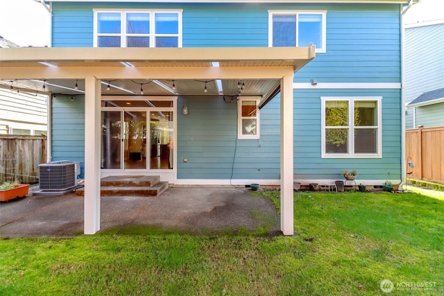 back of property featuring entry steps, cooling unit, fence, a yard, and a patio area