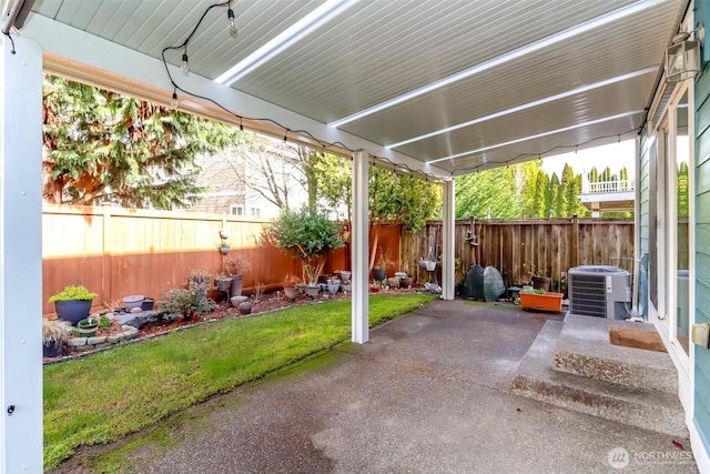 view of patio with central AC unit and a fenced backyard