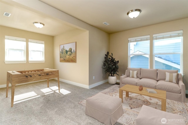 carpeted living area with visible vents and baseboards