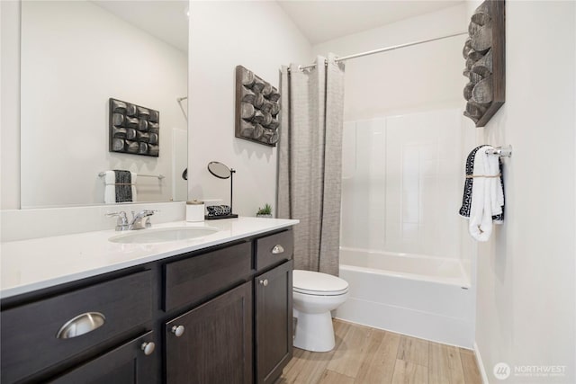 full bathroom with hardwood / wood-style flooring, toilet, vanity, and shower / tub combo with curtain