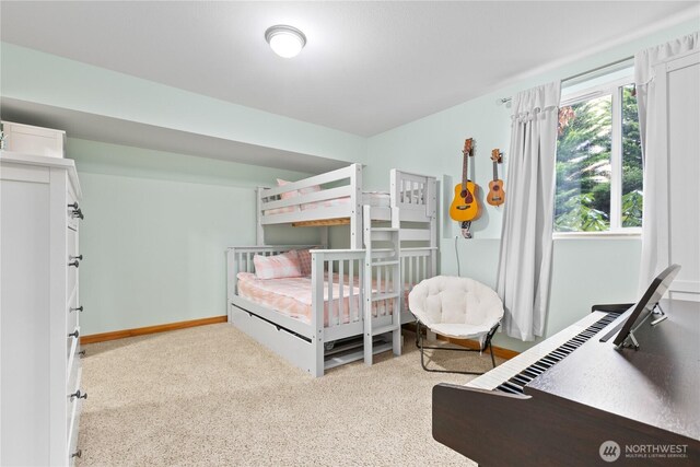 bedroom with light carpet and baseboards