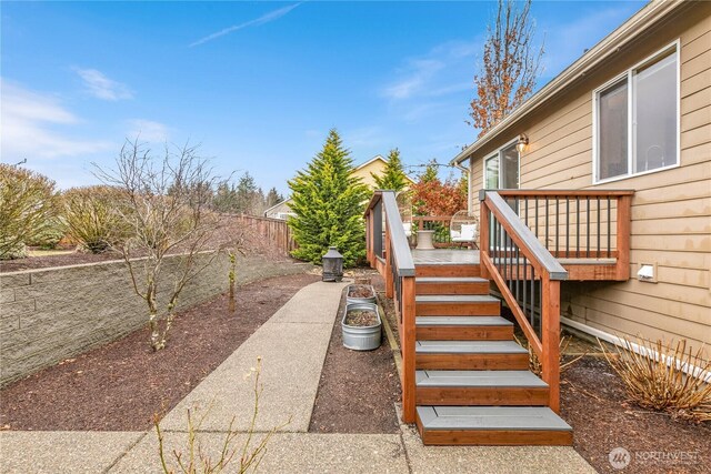 view of yard featuring stairway, a fenced backyard, and a deck