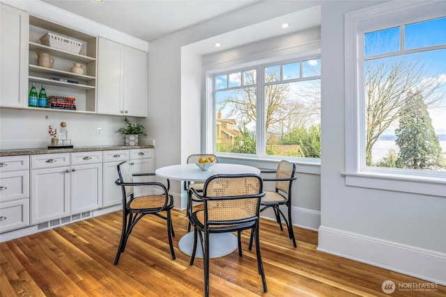 dining room featuring recessed lighting, wood finished floors, visible vents, and baseboards