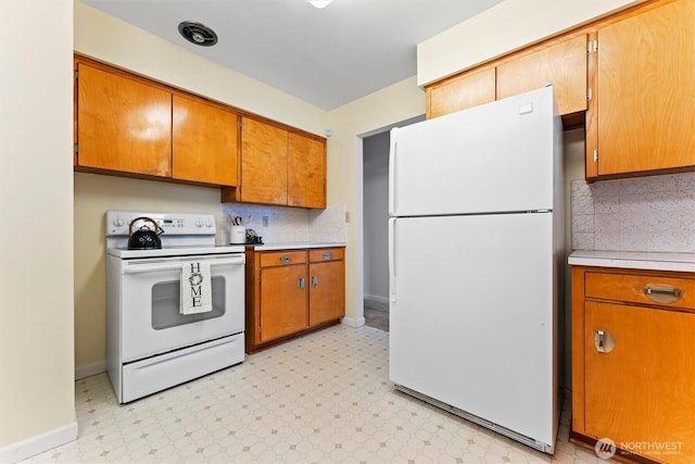 kitchen with brown cabinets, light floors, tasteful backsplash, light countertops, and white appliances