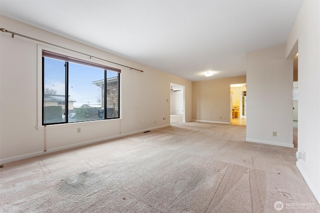 carpeted empty room with visible vents and baseboards