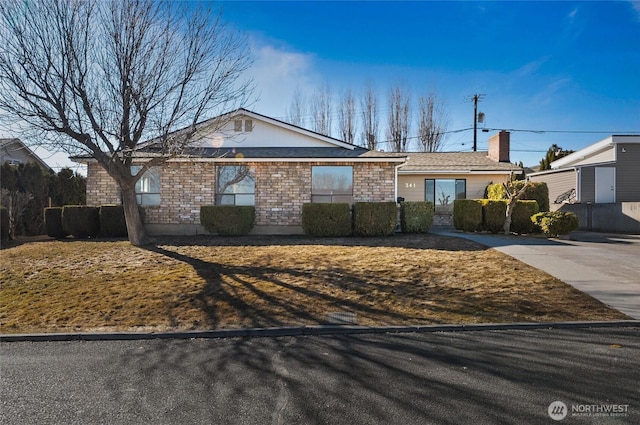 single story home featuring brick siding