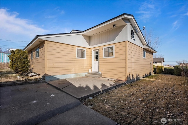 rear view of property featuring entry steps and a patio