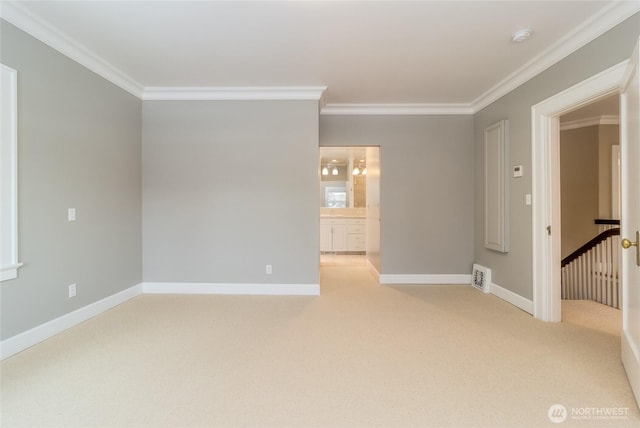 unfurnished room featuring baseboards, ornamental molding, visible vents, and light colored carpet