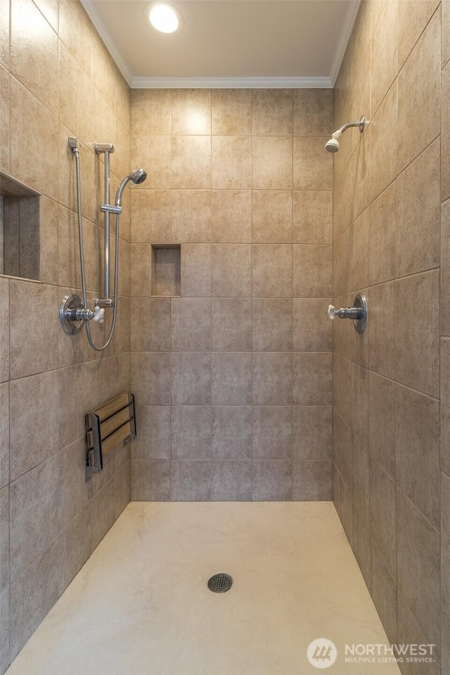 full bathroom with crown molding and tiled shower