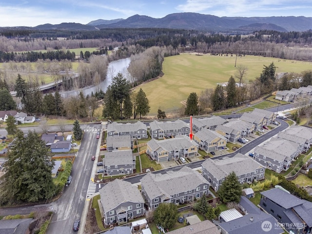 drone / aerial view featuring a residential view and a mountain view