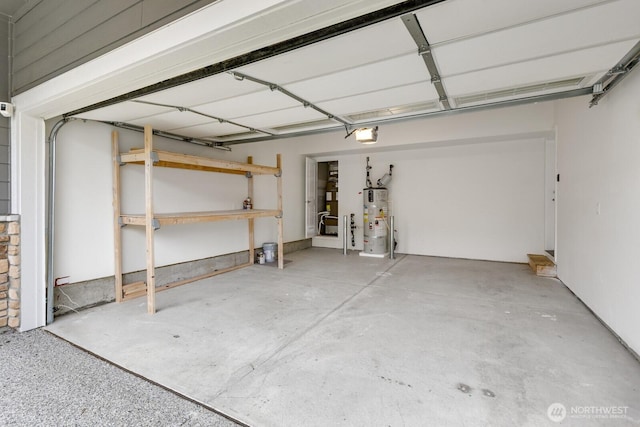 garage featuring water heater and a garage door opener