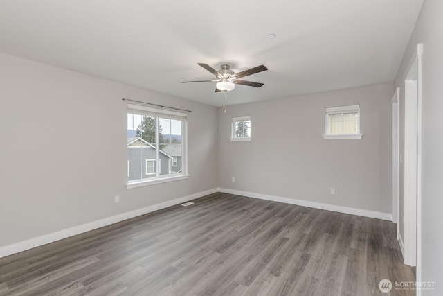 unfurnished room featuring ceiling fan, baseboards, and wood finished floors