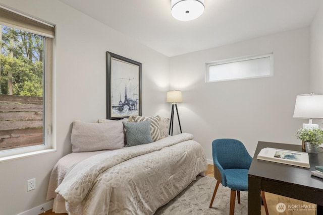 bedroom with baseboards and wood finished floors