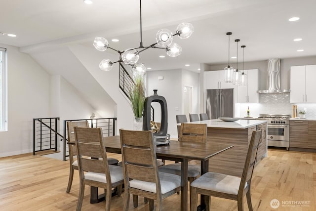 dining area with light wood-type flooring, baseboards, and recessed lighting