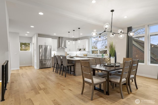 dining room featuring a wealth of natural light, baseboards, light wood finished floors, and recessed lighting