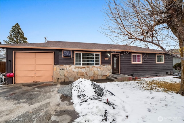 ranch-style house featuring a garage, stone siding, and driveway