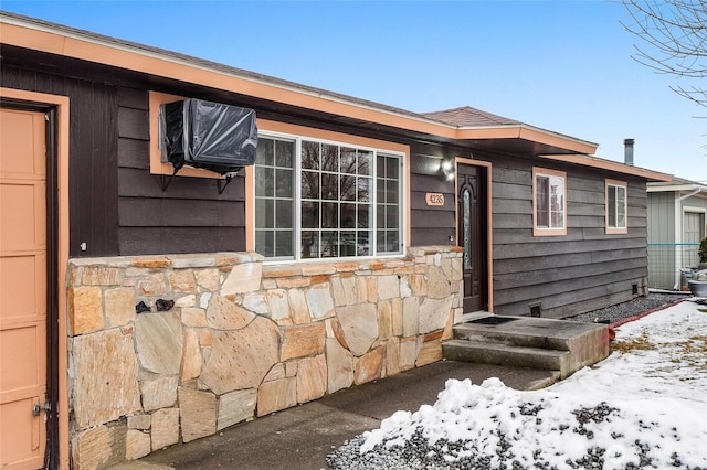 view of front of home featuring a garage and stone siding