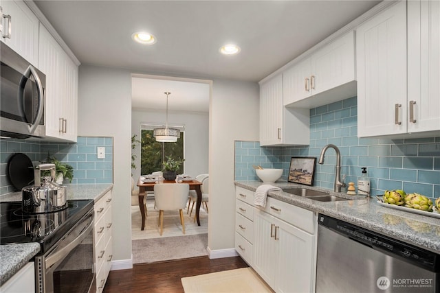 kitchen featuring white cabinets, dark wood-style flooring, stainless steel appliances, and a sink