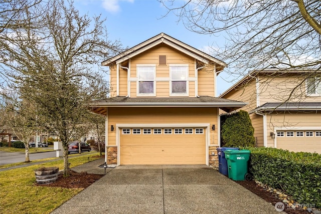 traditional-style house featuring concrete driveway, a garage, and stone siding