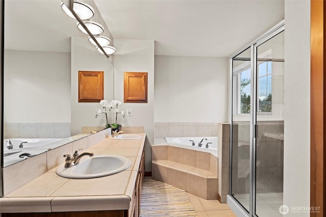 full bath with a sink, a garden tub, a shower stall, and double vanity