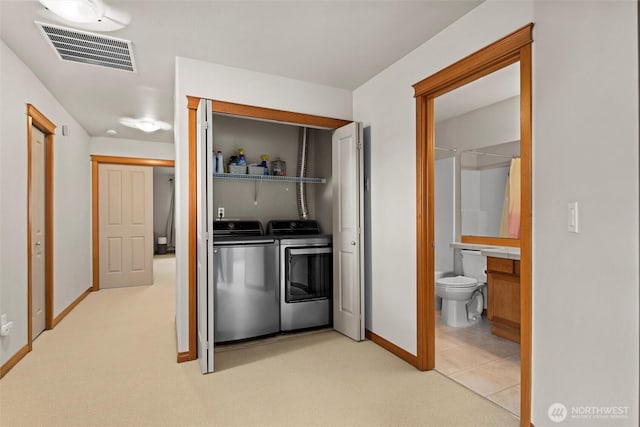 laundry room featuring visible vents, baseboards, light colored carpet, laundry area, and independent washer and dryer